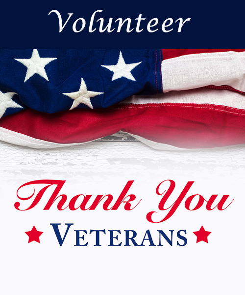 American flag draped on a table beside the words Thank You Veterans, framed by two red stars